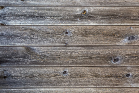 Old wooden shield made with horizontally located darkened with age planks with knots, textureの写真素材