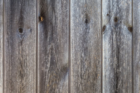 Old wooden shield made with vertically located darkened with age planks with knots, textureの写真素材