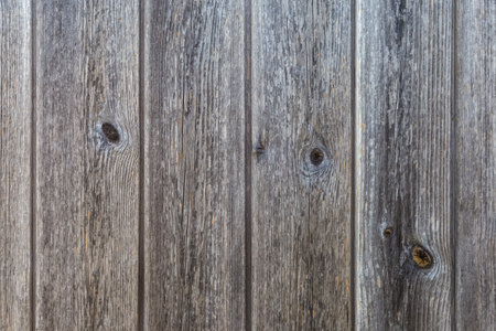 Old wooden shield made with vertically located darkened with age planks with knots, textureの写真素材