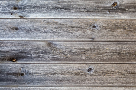 Old wooden shield made with horizontally located darkened with age planks with knots, textureの写真素材
