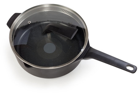 Empty deep frying pan made of cast aluminum with titanium non-stick coating closed with glass lid with stainless steel strainer on a white backgroundの写真素材