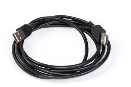 Coiled USB extension cable with plug and receptacle of Standard-A on the edges on a white backgroundの写真素材