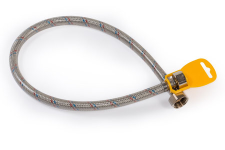 Flexible water hose with metal braid, brass threaded fittings and plastic tag on a white backgroundの写真素材