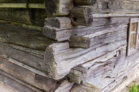 Fragment of the external corner of the medieval building with walls made with wooden logs connection in lockの写真素材