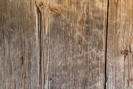Surface of the old wooden planks with knots, vertically located and darkened by time in a medieval buildingの写真素材