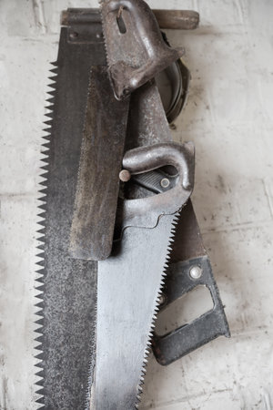 Old two-man crosscut saw and several hand crosscut saws with different size and shape of teeth...
