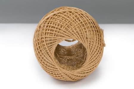 Small skein of the brown synthetic twine without spool on a white surfaceの写真素材