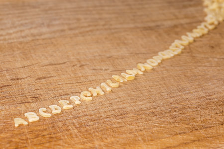 Raw pasta in shape of capital letters of English alphabet placed in line in the alphabetical order...