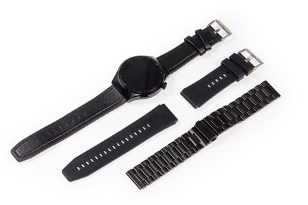 Black smart watch with round display switched off and leather strap, additional, or spare plastic strap and metal bracelet on a white backgroundの写真素材