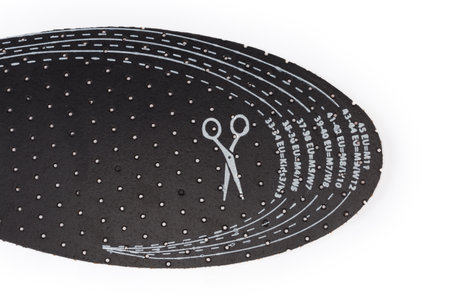 Insole in front with sizes designation according to the standards of different regions in order to ability to cut to the desired size, top view on a white backgroundの写真素材