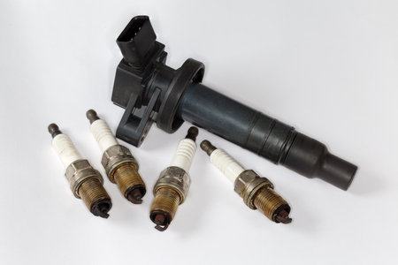 Used ignition coil of coil-on-plug system and spark plugs for petrol internal combustion engine of modern car on a white backgroundの写真素材
