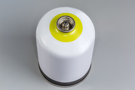 Disposable metal gas cartridge with threaded connection for camp stove on a gray backgroundの写真素材