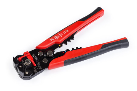 Multifunctional hand-held wire cutter with insulation stripper for strip the electrical insulation from electric wire during electrical installation works on a white backgroundの写真素材