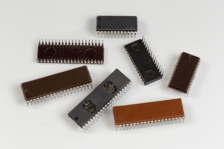 Different integrated circuits of CPU, microcontrollers and other in the plastic wide DIP packages for thru-holes mounting on printed circuit board on a gray surfaceの写真素材