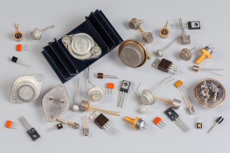 Old bipolar and field-effect transistors various purposes in different metal, ceramic and plastic packages on a gray surfaceの写真素材