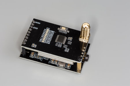 Small high-frequency electronic unit assembled on two black circuit printed boards with coaxial...