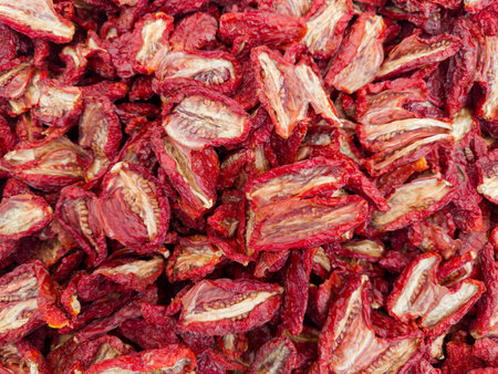 Heap of sundried tomatoes on a vegetable market, top view close-upの写真素材