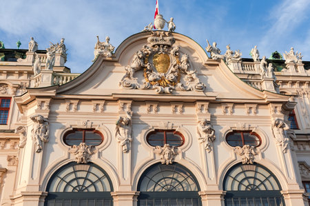 Central upper part of the main facade of Baroque palace Upper Belvedere of the 18th century illuminated by the evening sun, Vienna, Austriaの写真素材