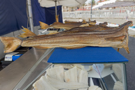Carcasses of the dried cod without heads on a coastal retail fish market outdoors