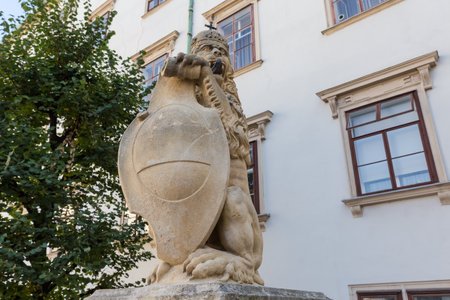 Sculpture of lion in crown and with shield in front of the Swiss Gate in Castle Hofburg, Vienna, Austria, view in a shade in sunny dayの写真素材