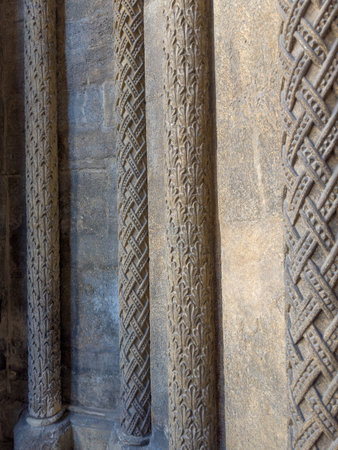 Decorations of the wall of gothic church in the form of columns with stone carved plant and other ornaments, fragment close-upの写真素材