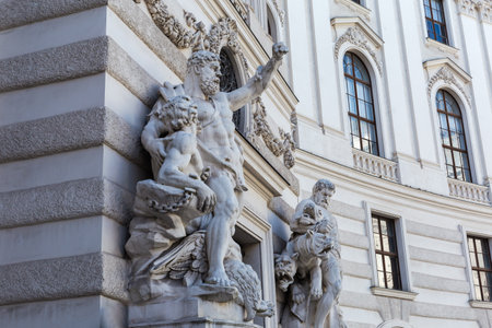 Groups of Hercules sculptures in north-eastern facade of the St. Michael's Wing of the Hofburg in overcast, Vienna, Austriaの写真素材