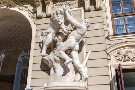 Sculpture of Hercules which kills the Nemean Lion in south-western facade of Imperial Chancellery of the St. Michael's Wing of the Hofburg in sunny day, Vienna, Austriaの写真素材