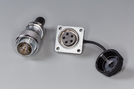 Pair of industrial circular metal electrical connectors of straight plug with threaded union nut and...