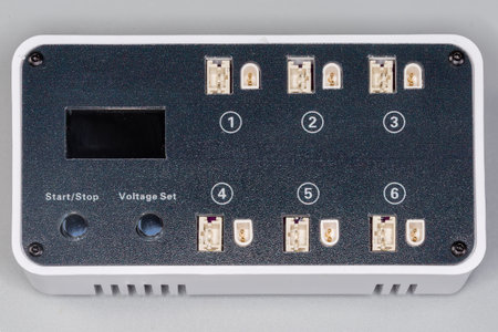 Smart multichannel battery charger with liquid-crystal display for independent charging of several lithium polymer batteries on a gray background, top viewの写真素材
