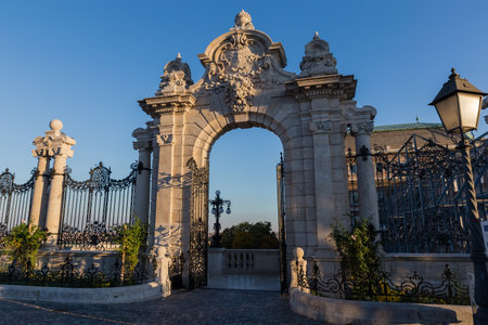 Open neo-baroque gate to the castle garden on a Danube terrace of the Buda Castle at sunny autumn...