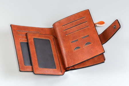 Open brown leather wallet in classic style with several cards compartments and coin purse with...