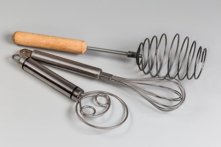 Different stainless steel hand kitchen whisks for kneading dough and whipping various ingredients...