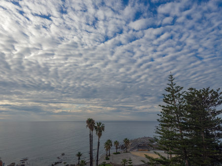 Section of the sky with cumulus, altocumulus and storm clouds over the sea at morningの写真素材