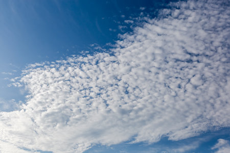 Section of the blue sky with stratocumulus floccus clouds at summer sunny dayの写真素材