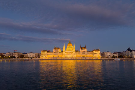 Main facade of the Hungarian Parliament Building with night lighting, view from the west bank of the Danube at evening, Budapestの写真素材