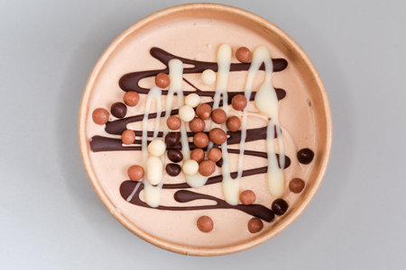 Decoration made of the dark and white chocolate, dark and light cocoa rice balls on the top of ice...