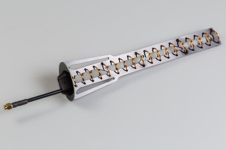 Small-sized helical antenna of high-frequency mobile electronic unit with coaxial connector on the...