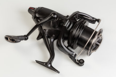 Modern multiplier baitcasting fishing reel for the recreational fishing on a gray backgroundの写真素材