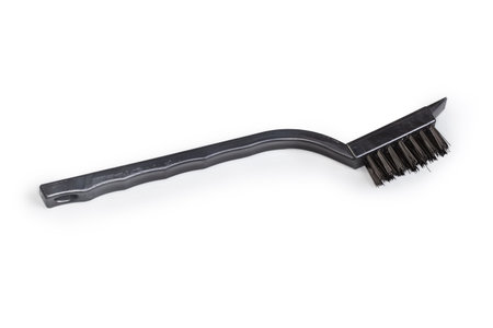 Manual brush with hard plastic bristles on the black plastic handle on a white backgroundの写真素材