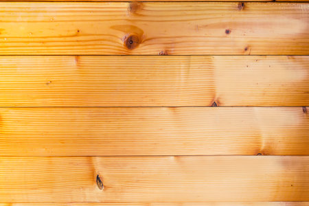Part of the wall lined with horizontal varnished wooden beams, made with softwood indoors, texture, background,の写真素材