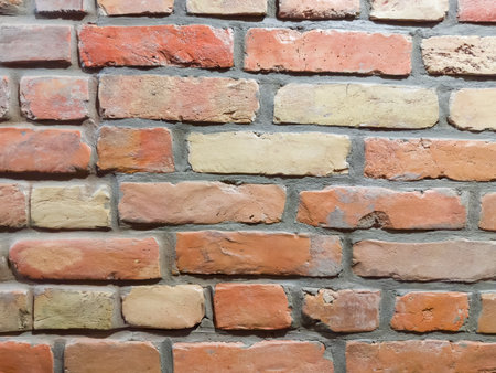 Fragment of the old rough wall, built of the red and yellow bricks close-upの写真素材
