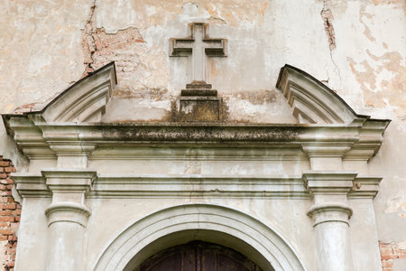 Fragment of decorations in main facade of abandoned Baroque Church of Saint Anthony of the 18th century in overcast day in Velyki Mezhyrichi, Ukraineの写真素材