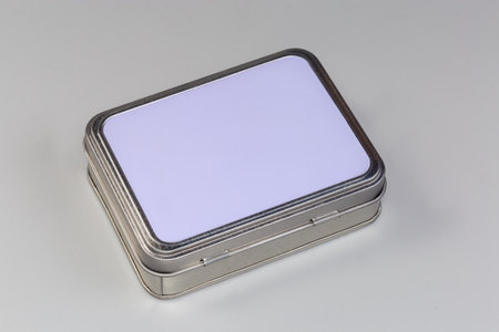 Closed small rectangular tin box with opening lid to store various small household items, medicines,...