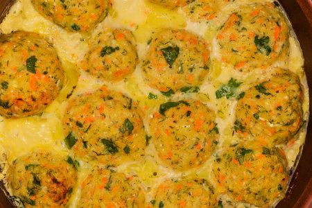 Baked and then stewed salmon patties of circular shape, fragment top view close-up
