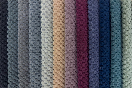 Narrow strips of soft textile different colors stacked next to each other and forming a color palette, top view, backgroundの写真素材