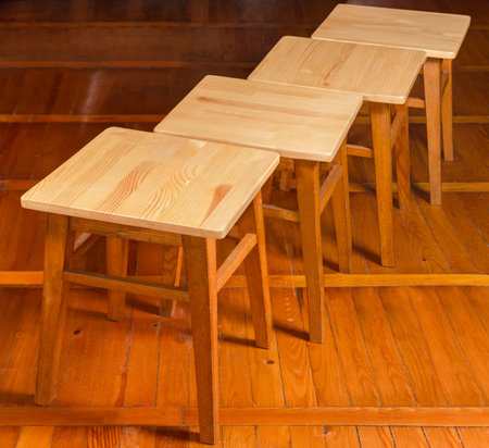 Four classic kitchen stools with frames on four straight legs with crossbars made of natural solid...