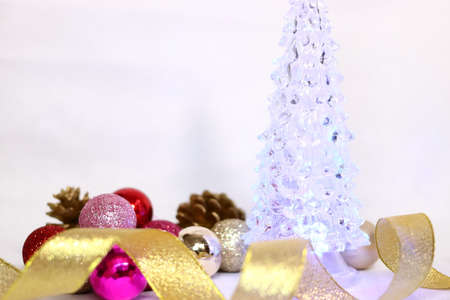 Christmas tree background texture with pink and red and golden colorful decorations (white background)の写真素材