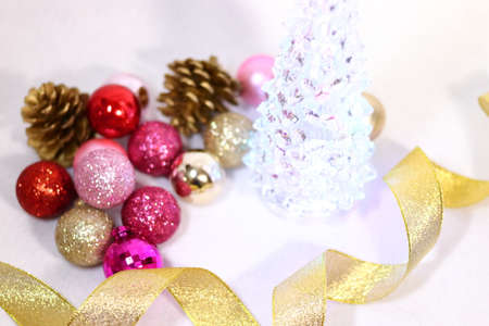 Christmas tree background texture with pink and red and golden colorful decorations (white background)の写真素材
