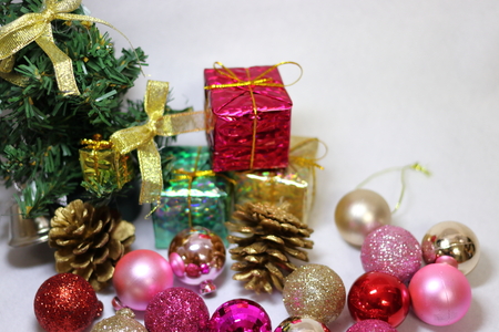 Pink and gold etc. colorful glitter Christmas decorations, ribbon and Christmas tree on white backgroundの写真素材