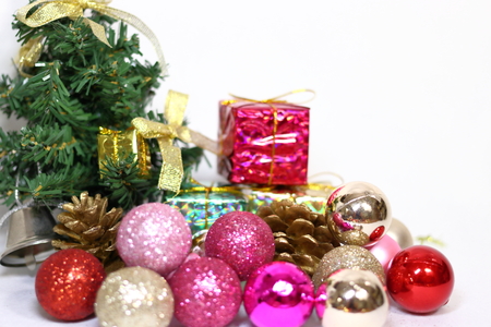 Pink and gold etc. colorful glitter Christmas decorations, ribbon and Christmas tree on white backgroundの写真素材